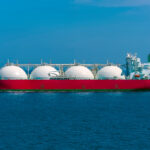a large red ship with white spheres on it